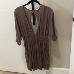Low cut tan dress. open back with pockets.